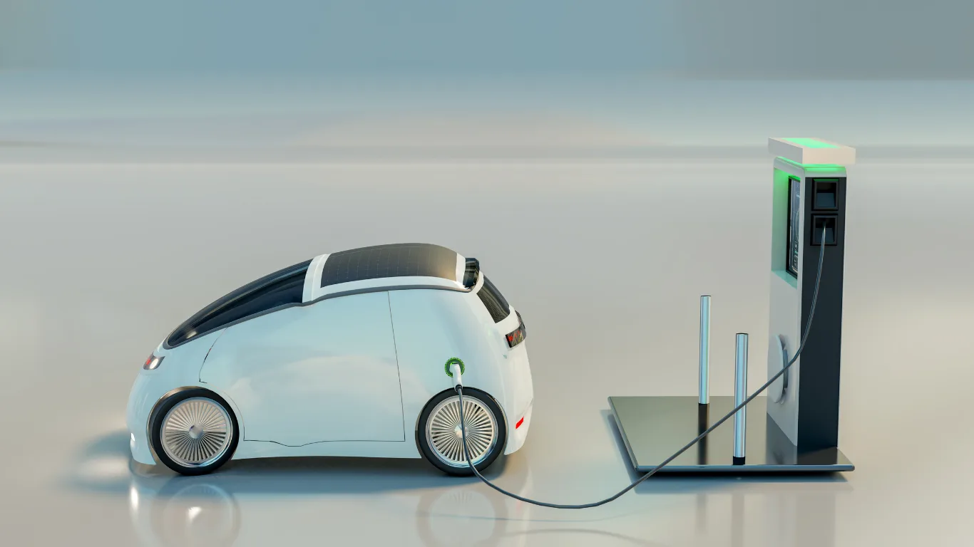 White futuristic electric car plugged into a charging station with a tall charger on a glossy floor